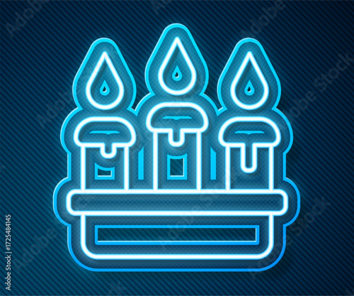 Glowing neon line Burning candle in candlestick icon isolated on blue background. Cylindrical candle stick with burning flame. Vector