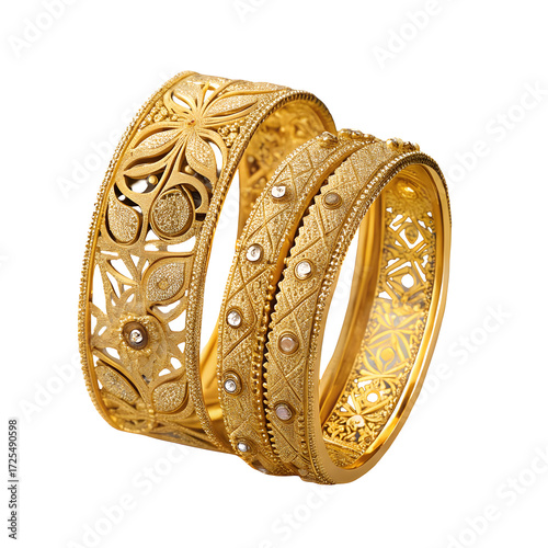 A close up of two intricately designed gold bangles with floral and geometric patterns on white background