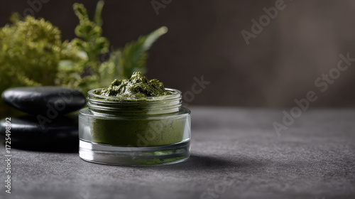 Soothing matcha concept is captured in this featuring green herbal paste in glass jar surrounded by natural elements