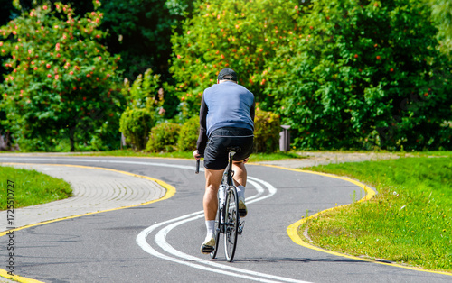 Wallpaper Mural Cyclist ride on the bike path in the city Park
 Torontodigital.ca