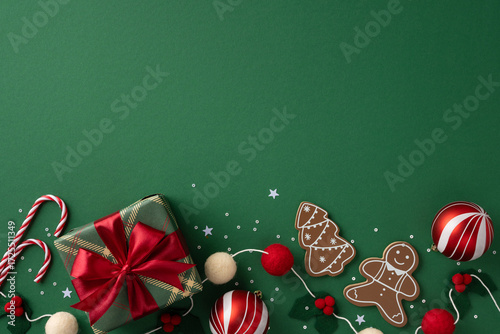 Vibrant Christmas celebration scene featuring a wrapped gift with red ribbon, candy canes, gingerbread cookies, and ornaments on a green background, evoking festive cheer gifts and holiday greetings