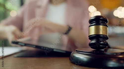 Scene showing the blend of traditional law symbolized by gavel with digital note-taking on tablet