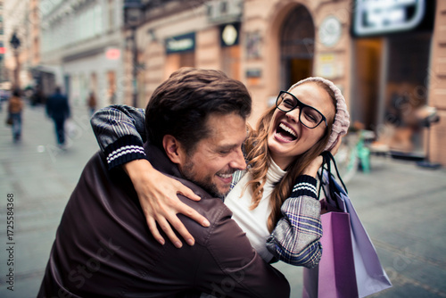 Happy couple embracing in city