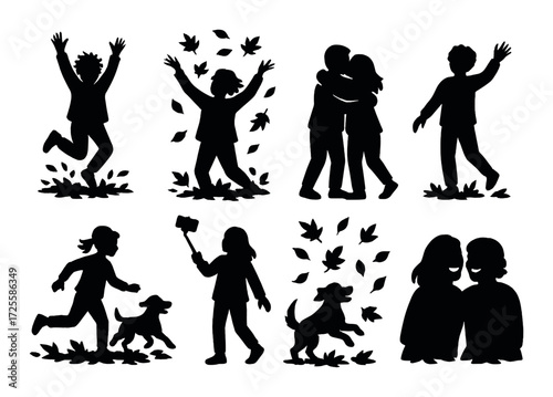 Silhouettes of children and dogs playing in autumn leaves