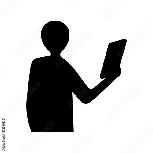 Silhouette of a person reading or using a tablet device standing up