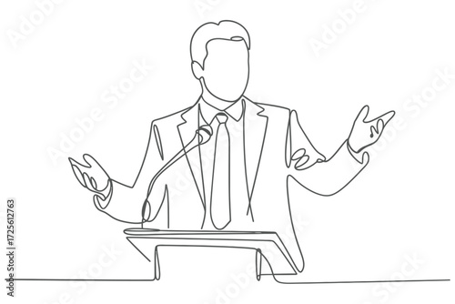 Man in suit speaking at a podium with microphone