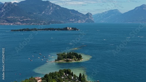 Wallpaper Mural Drone footage 4K captures Isola di San Biagio near Manerba del Garda, Italy, surrounded by turquoise lake water. Torontodigital.ca