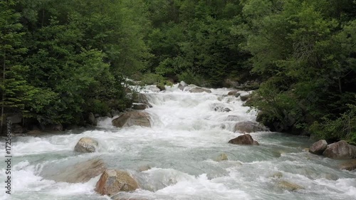 Wallpaper Mural Very low flight over a mountain river upstream. Drone flight, mountain river. Clear stream running through stone boulders Abundant river flowing on stone bottom in slow motion. Torontodigital.ca