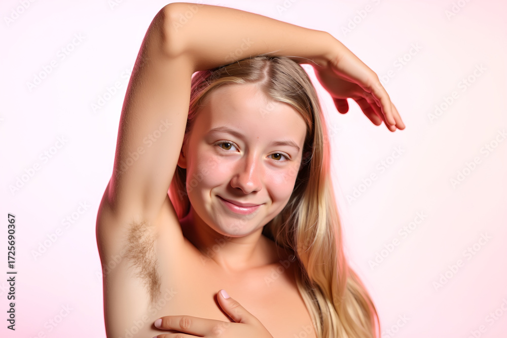 Fototapeta premium Young woman, teenage girl with naturally hairy armpits, the new trend back to nature, not shaving armpit hair.