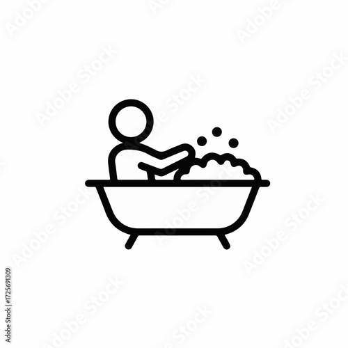 Person enjoying a relaxing bubble bath with soap suds and bubbles.