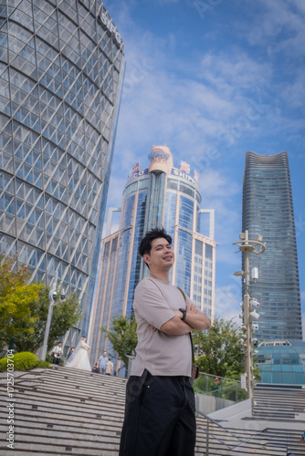Photography A man stands on a staircase in front of a tall building