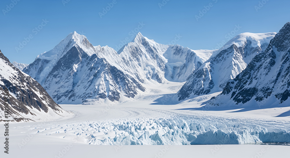 Obraz premium A panoramic view of snow covered mountains and a glacier under a clear blue sky in a remote location