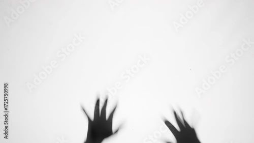 Shadow of a zombie hand on white background
