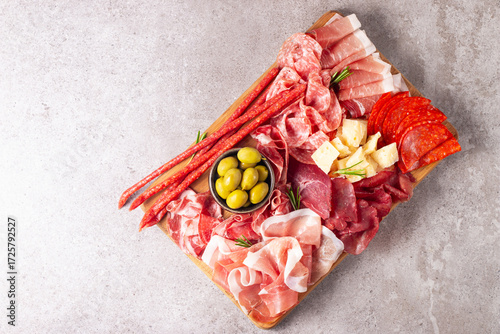 Charcuterie board. Antipasti appetizers of meat and cheese platter with salami, prosciutto crudo or jamon and olives