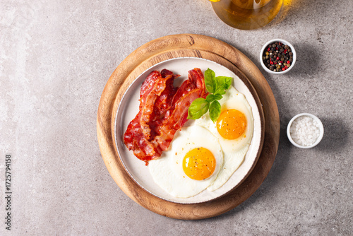 Delicious traditional English breakfast with fried eggs and bacon