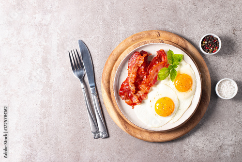 Delicious traditional English breakfast with fried eggs and bacon