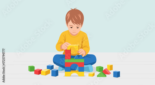 Young boy sitting on the floor building with colorful toy blocks