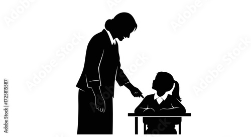 Dedicated teacher guiding student at desk
