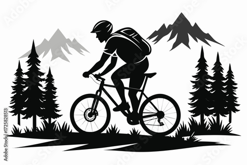Silhouette of a mountain biker riding through a forest landscape
