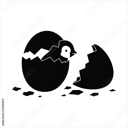 Cute baby penguin hatching from a cracked egg symbolizing new life and beginnings