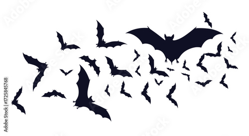 A group of bats flying in a dark sky.