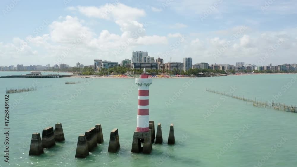 View of the sea with a lighthouse and the city of fortaleza in the background