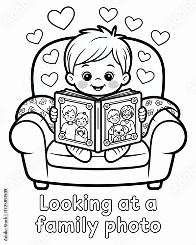 A young child reading a photo album in a cozy armchair