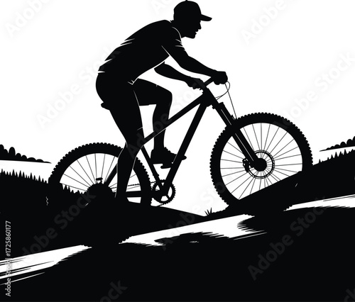 Dynamic silhouette of a mountain biker riding down a steep hillside