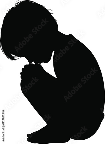 Silhouette of a young child kneeling with head bowed in contemplation