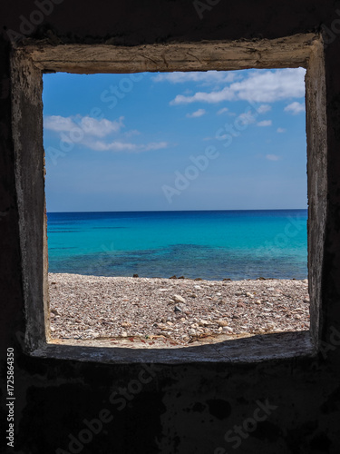 Wallpaper Mural Scenic view of the turquoise Arabian Sea through a rustic stone window frame on the coast of Socotra Island Torontodigital.ca