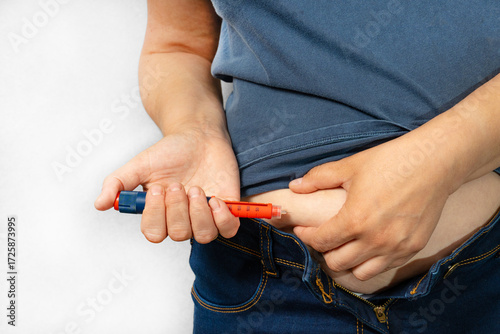 Woman doing insulin injection pen, close-up. Diabetic patient with insulin pen for control diabetes hormone therapy. Selective focus.