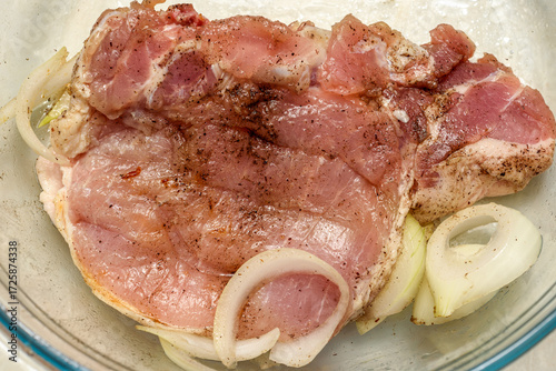 Raw meat marinated with onions before frying.