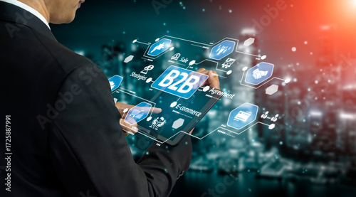 Billede på lærred A business professional interacts with a digital interface showcasing various icons and graphics, symbolizing the evolving landscape of B2B marketing and transactions