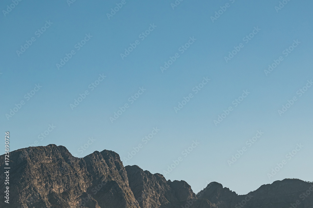 Obraz premium Mountains and blue sky, travel background with copy space