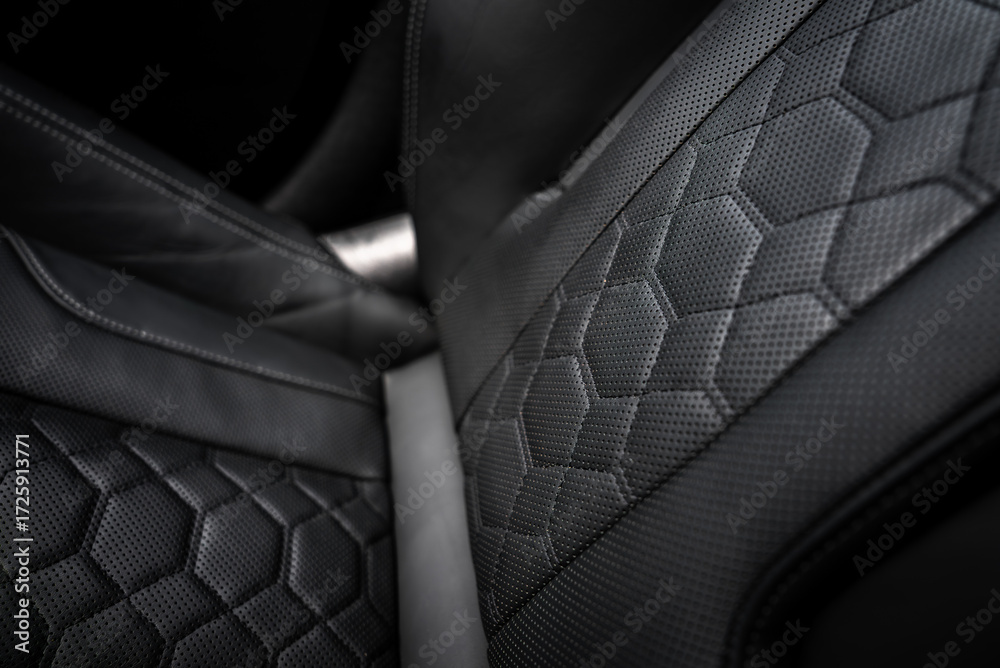Naklejka premium Detailed view of a BMW X4 car seat featuring perforated leather, hexagonal quilting, and precise stitching, highlighting premium craftsmanship.