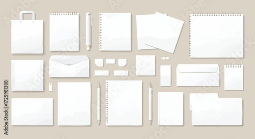 A collection of blank white stationery items, including envelopes, notepads, paper, and bags, arranged on a neutral background.