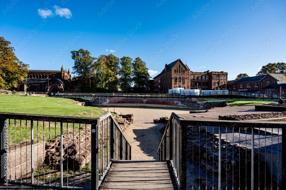 Obraz premium Chester, England, United Kingdom - September 21, 2025 - Downtown Chester in the Cheshire region of England as seen from the area near the city walls and the Roman Ruins. The area features Roman Ruins