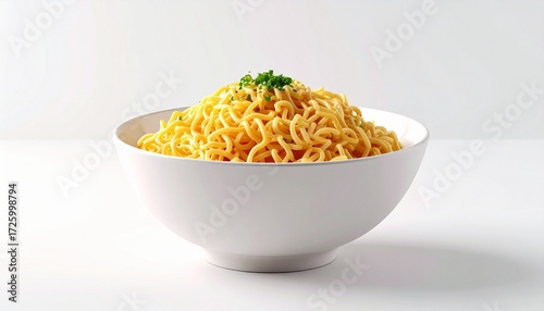 White bowl of cooked instant noodles topped with green herbs on white background