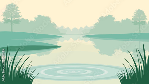 Serene lake landscape with misty trees and grass in foreground