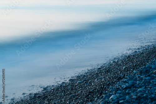Close up view of the Black Sea at sunset in Georgia with rocks in the water, perfect for travel, tourism, and nature themes.