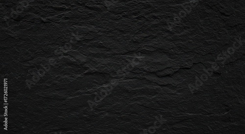 Close-up of a rough, dark, textured surface, revealing natural imperfections and patterns.