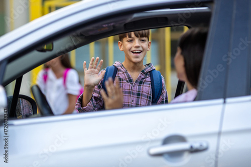 Boy saying bye to mom before entering school ground
