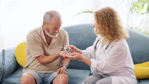 Elderly man receiving medication from caring doctor
