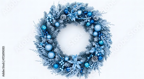 A christmas wreath with blue ornaments and frosted pine branches on a white background circular design