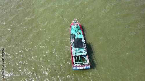 Aerial View of Fishing Boat Floating on Green Ocean Waterscape
