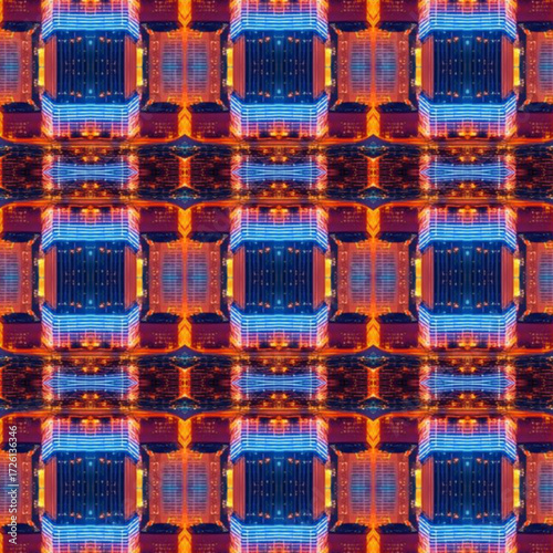 Kaleidoscopic city lights forming glowing geometric patterns in blue and orange, ideal for abstract, futuristic, and technology designs. Abstract, city, kaleidoscope, lights, pattern.