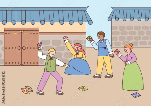 Foreign tourists in hanbok enjoy playing traditional Korean game ttakji in a hanok courtyard.