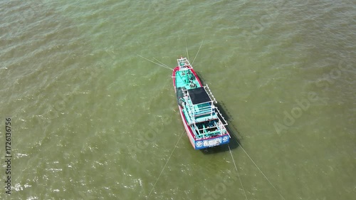 Aerial View of Fishing Boat Navigating Calm Water From Above