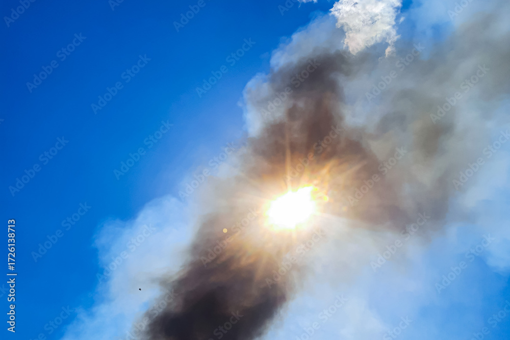 Fototapeta premium The sun shining through the smoke from forest fires is causing great tragedy for the environment and local residents, causing huge losses in millions of US dollars.