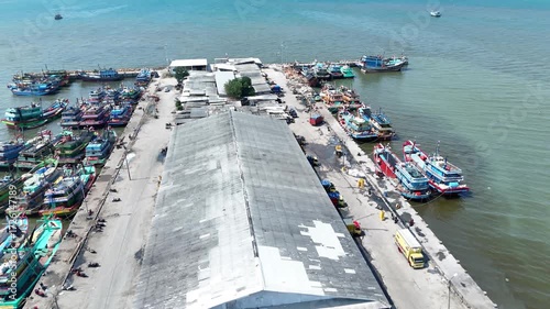 Aerial View of a Bustling Port with Fishing Boats Moored Densely